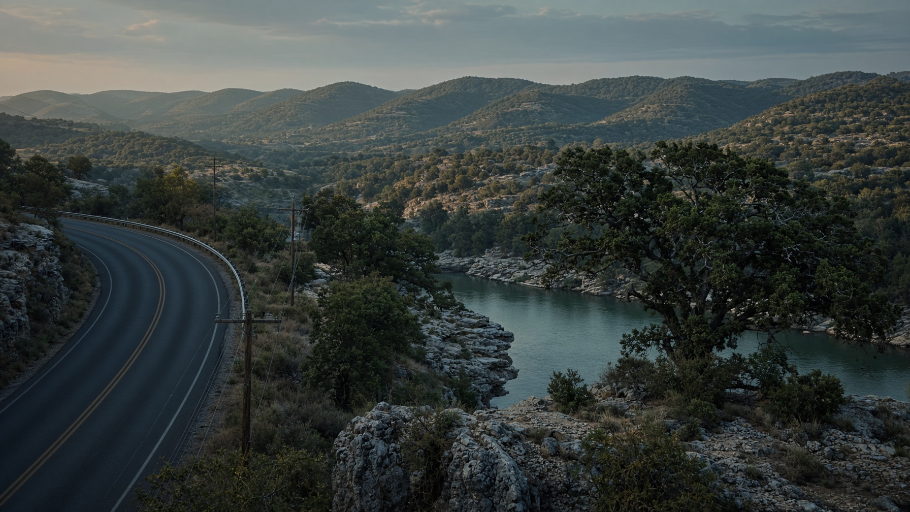 Texas Hill Country limestone bluff, live oak, and a utility right-of-way